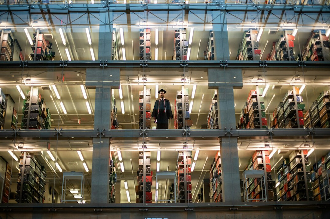 Tall shelves full of books and archive volumes in a library