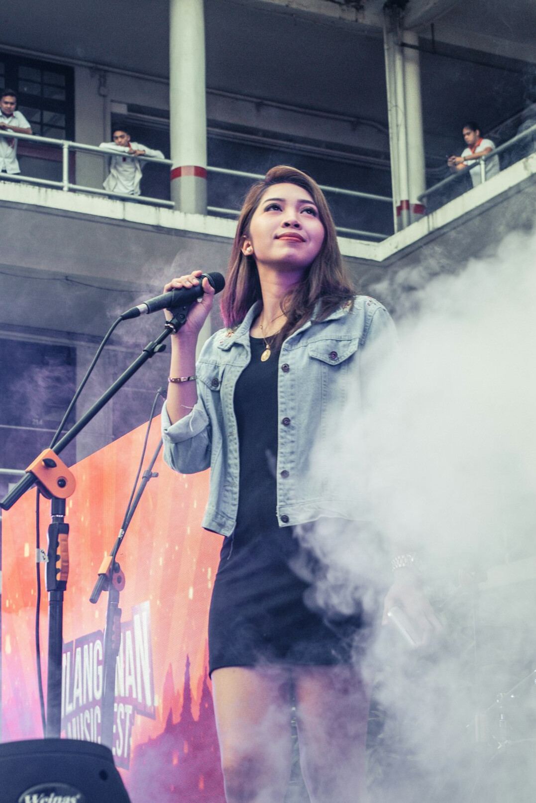 woman singing on stage